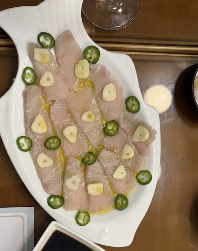 Thin slices of raw white fish dressed with olive oil, sliced garlic and green chilli